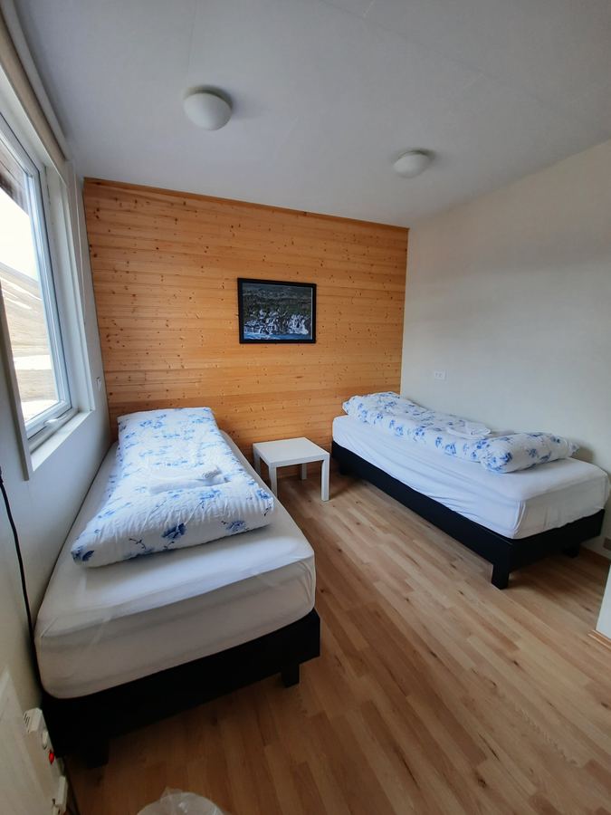 Twin room with wood panelling